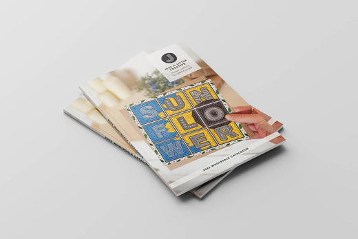 two copies of Jess A Little Creative's 2023 wholesale catalogue laid down on a grey background