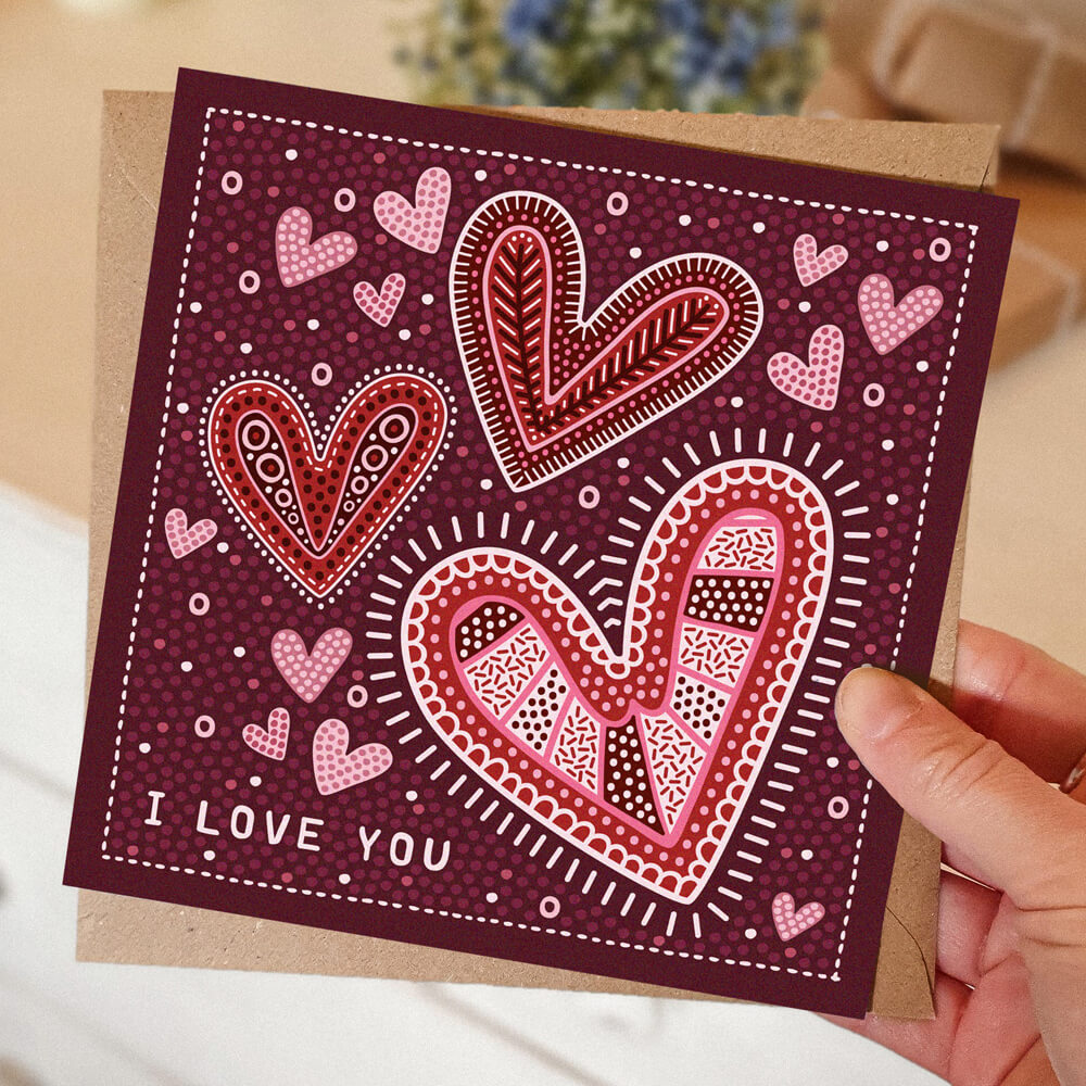 dark red romantic anniversary card featuring illustrated hearts and i love you message. Supplied with recycled kraft brown envelope
