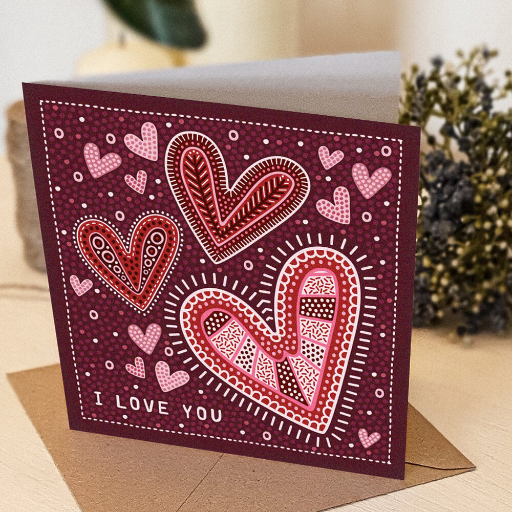 red, pink and white romantic anniversary card, featuring i love you message and illustrated hearts in folk-art style. Supplied with a kraft brown recycled envelope