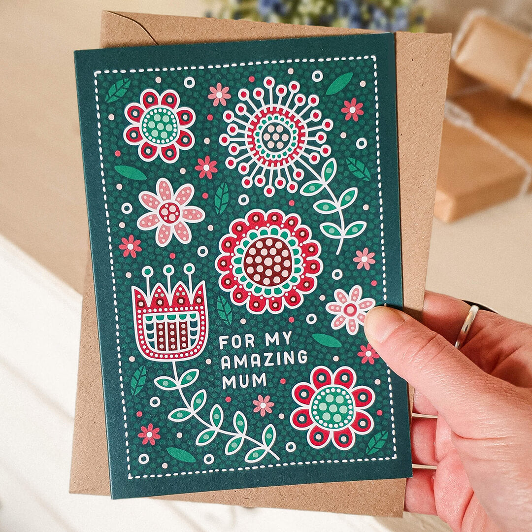 dark green, red and white floral mothers day card featuring folk art illustrations and 'for my amazing mum' message. Supplied with a recycled kraft brown envelope