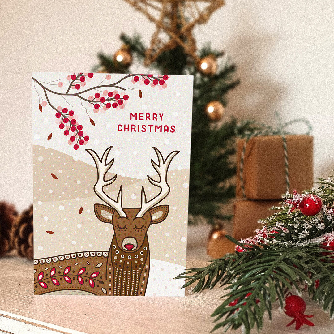Unique illustrated stag Christmas card with Christmas tree and gifts in background