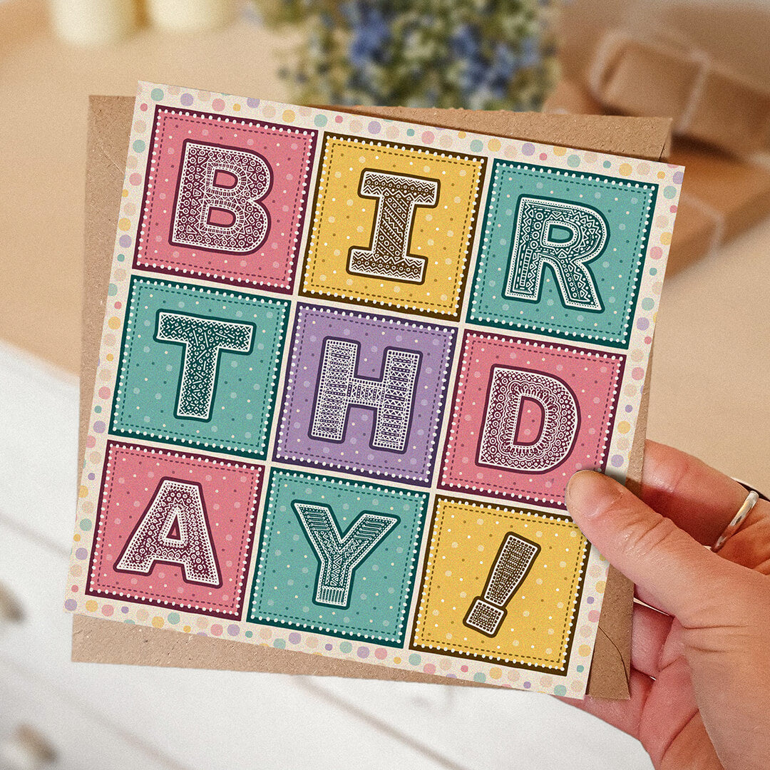 Hand holding colourful girly birthday card Pink yellow and turquoise typographic birthday card Printed on FSC-certified card with kraft brown recycled envelope Blank inside