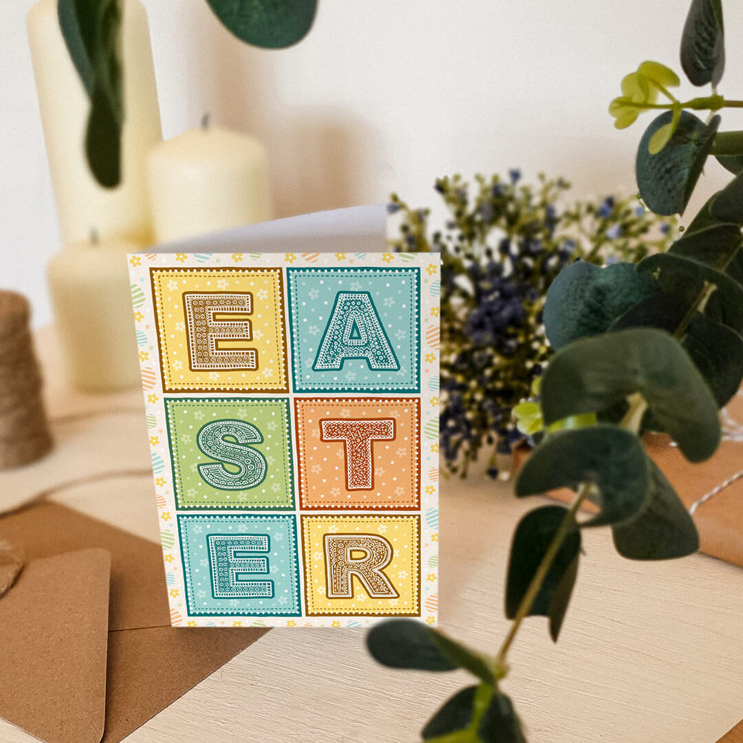 pastel typographic easter card decorated with flower and egg illustrations supplied with recycled kraft brown envelope