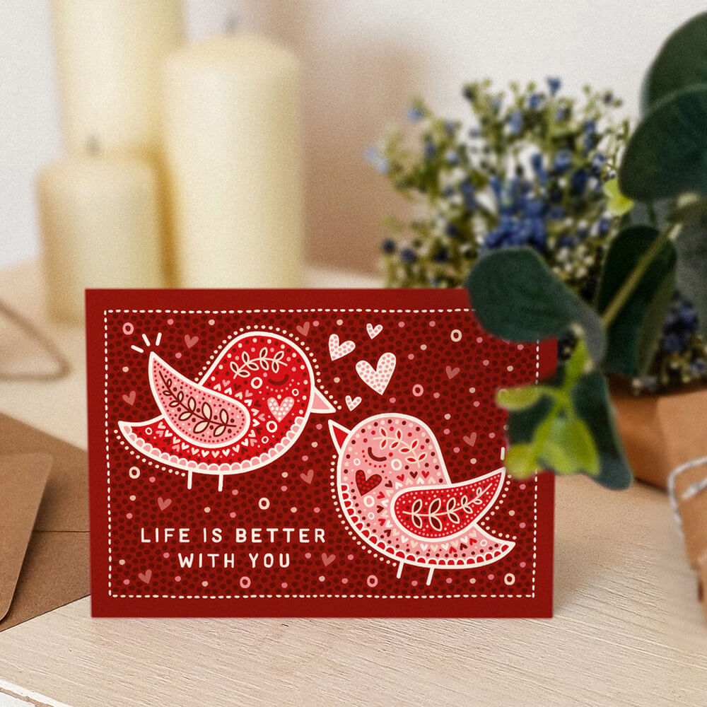 sweet anniversary card with life is better with you message alongside red lovebirds illustration. Supplied with recycled envelope. Blank inside