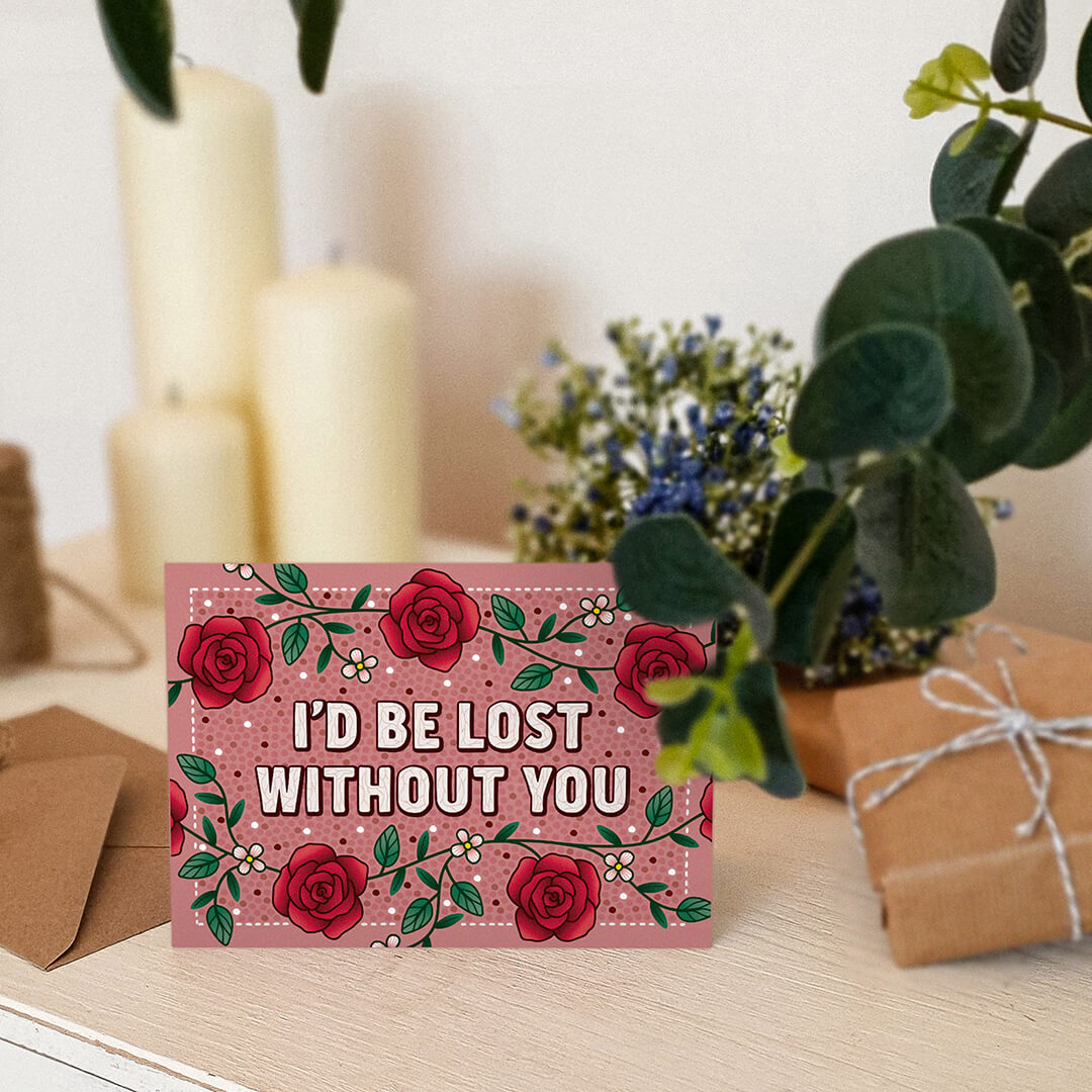 unique and romantic anniversary card featuring red rose illustrations and i'd be lost without you message blank inside recycled kraft brown envelope