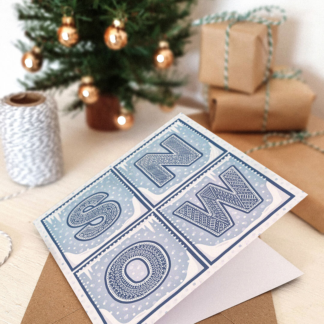 Snow Christmas card with 'SNOW' text on a festive background with presents and a Christmas tree.