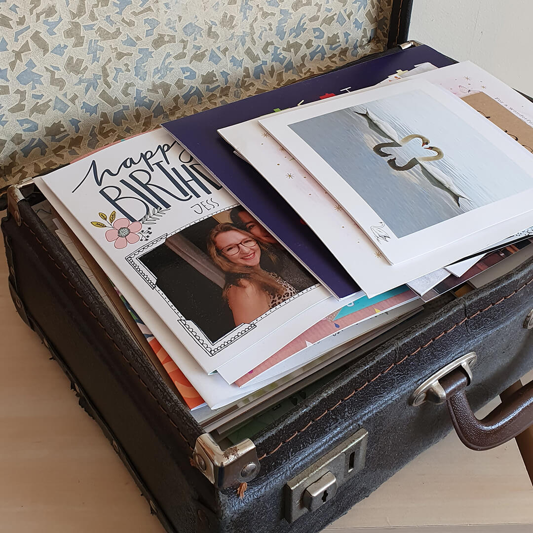 old suitcase containing lots of greeting cards