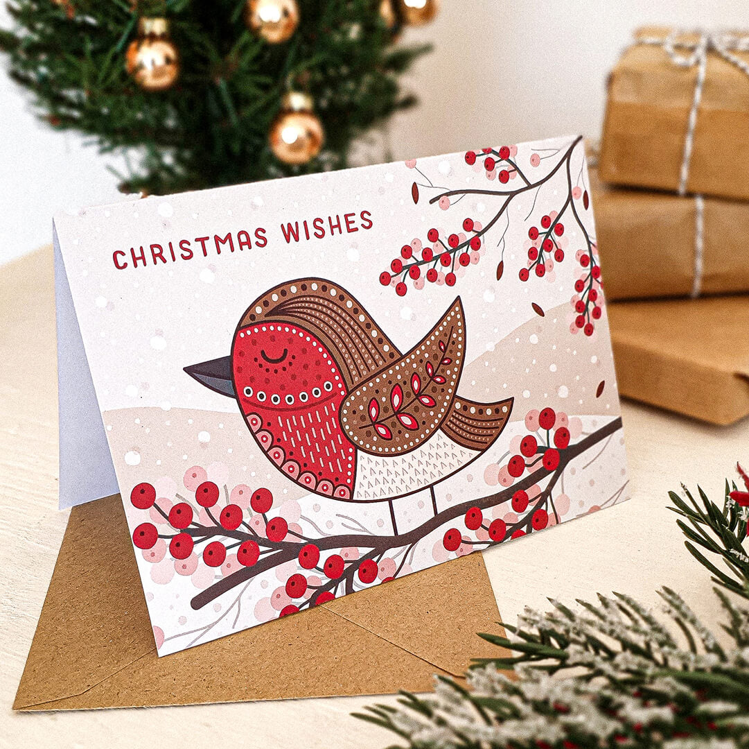 Unique illustrated robin Christmas card with Christmas tree and gifts in background