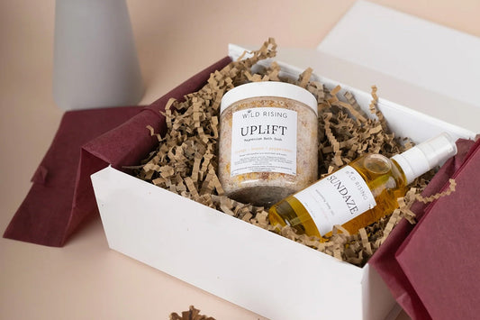 Organic skincare gift set in a cream gift box sat on a pale pink background