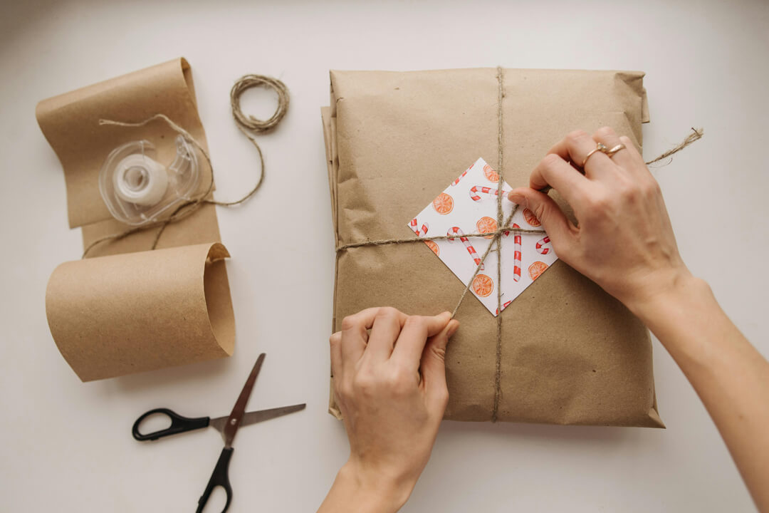 christmas gift wrapped in brown paper with handmade christmas gift tags