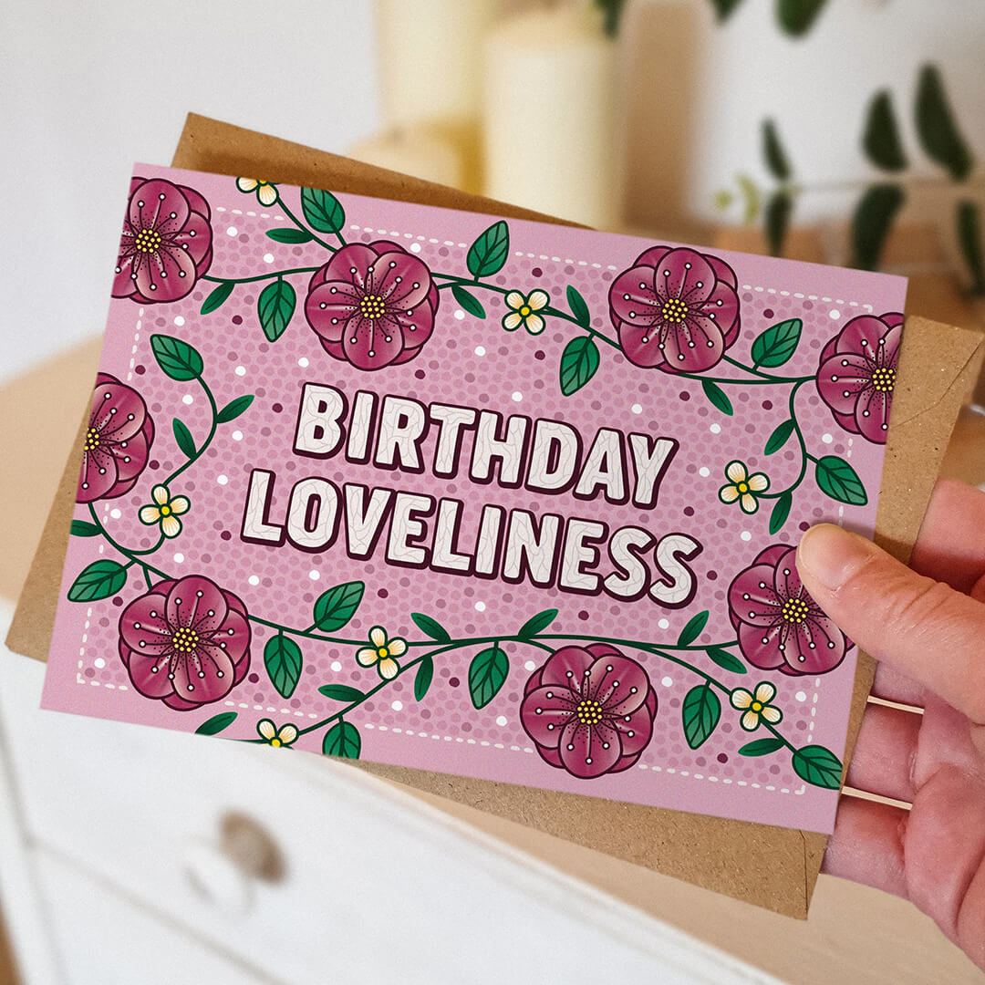 hand holding unique pink floral birthday card for friend blank inside recycled kraft brown envelope