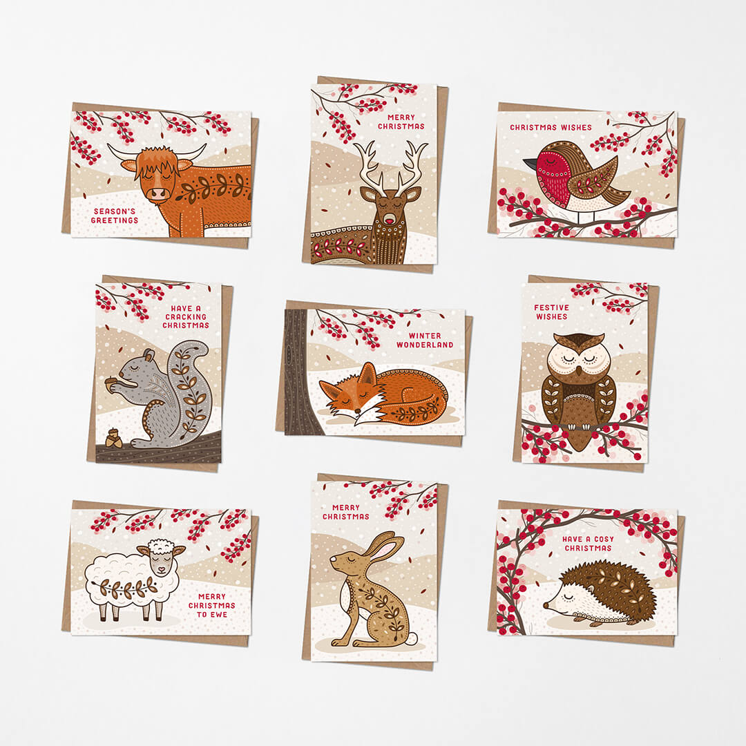Nine Christmas cards arranged in a 3x3 grid on a light background. Each card features a different woodland animal illustration with red berries and holiday messages.