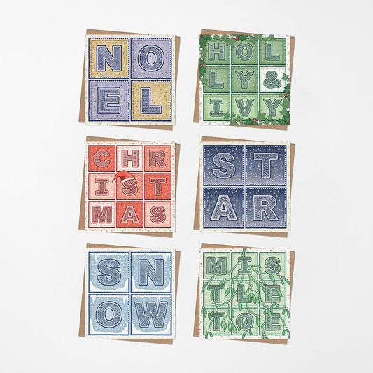 Set of six typographic Christmas cards with various typographic designs on a white background.