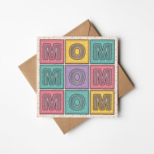 Colourful 'MOM' Mother's Day card with a brown envelope on a white background