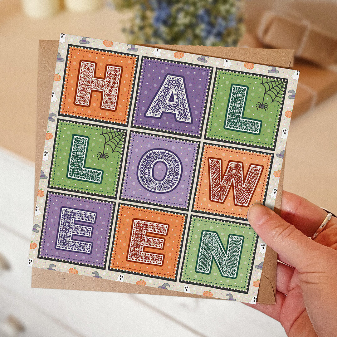 hand holding unique purple orange and green typographic halloween card Printed on FSC-certified card Blank inside