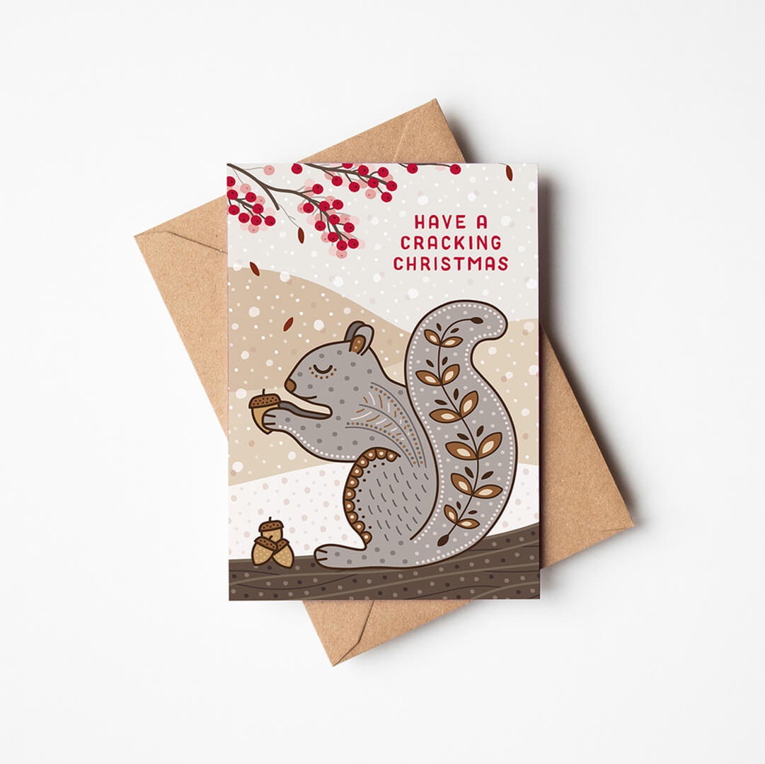 cute grey squirrel christmas card with a kraft brown envelope on a white background