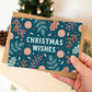 Hand holding unique dark blue nature Christmas card with festive plant illustrations of orange slices, berries and leaves Printed on FSC certified card Supplied with kraft brown recycled envelope