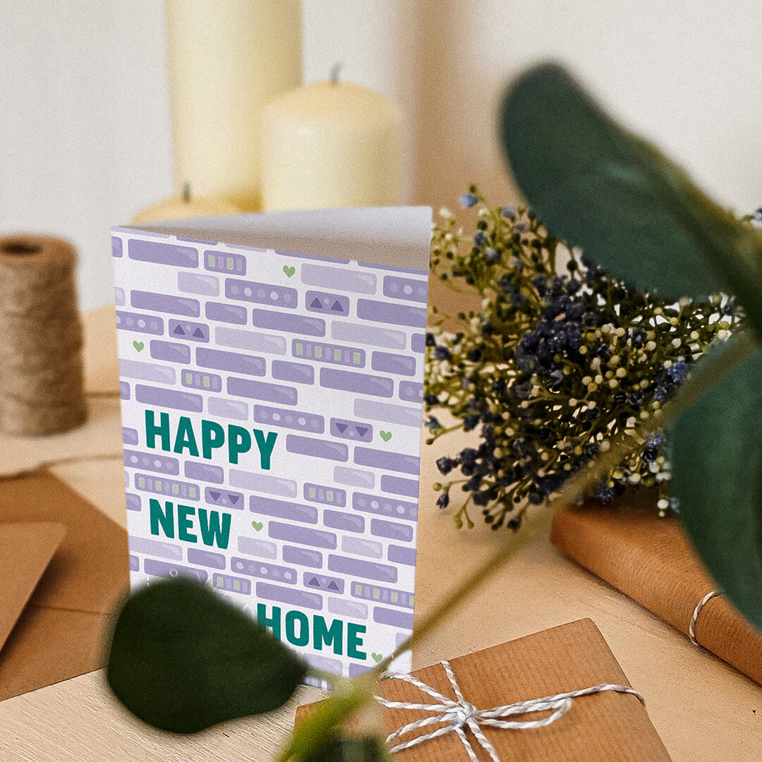 green and purple unique new home card featuring brick illustration blank inside recycled kraft brown envelope