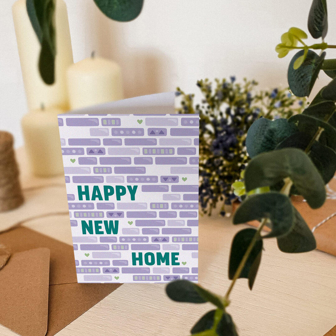 green and purple happy new home card featuring unique brick wall illustration blank inside recycled kraft brown envelope