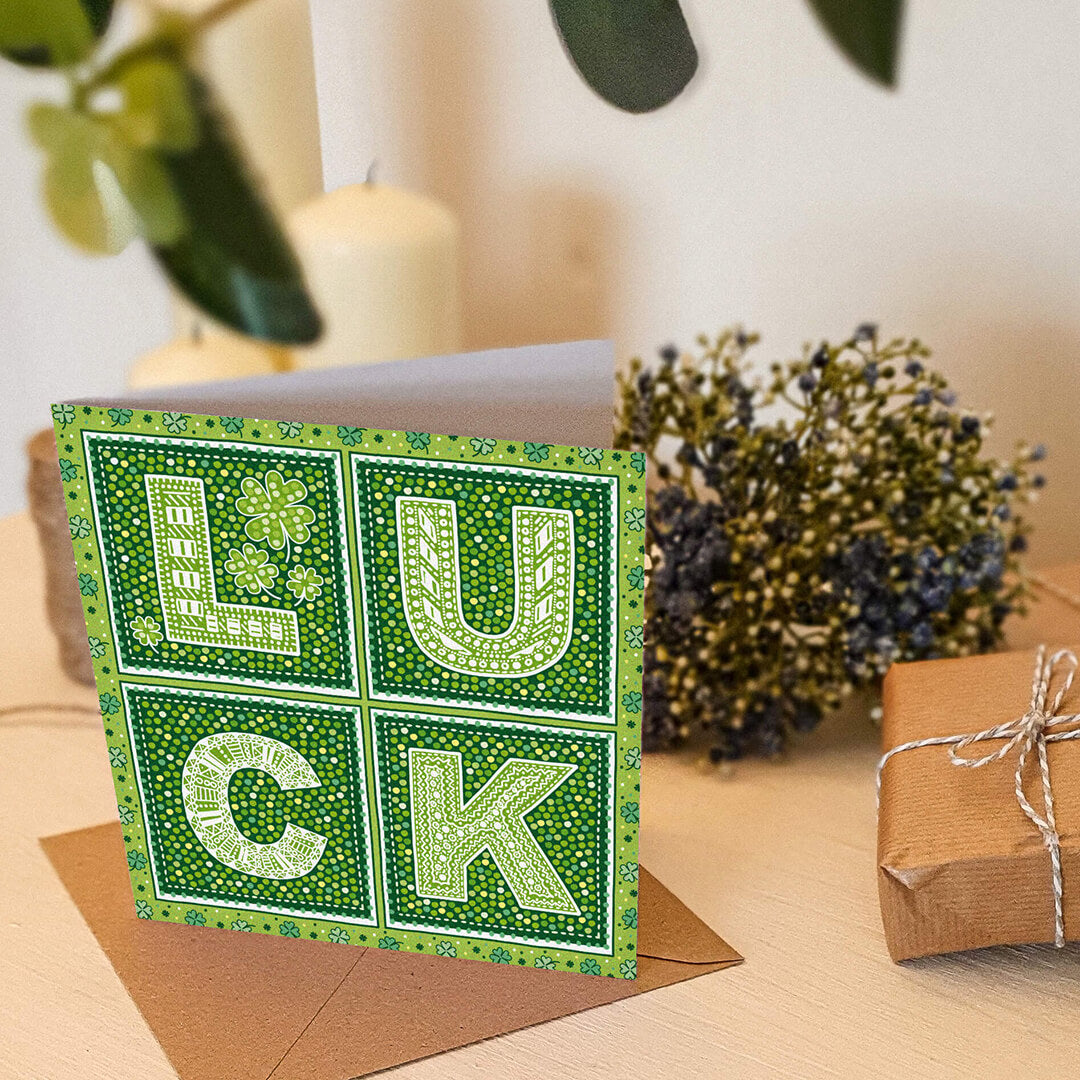 lifestyle shot of green shamrock good luck card Unique good luck card for friend Kraft brown recycled envelope Blank inside