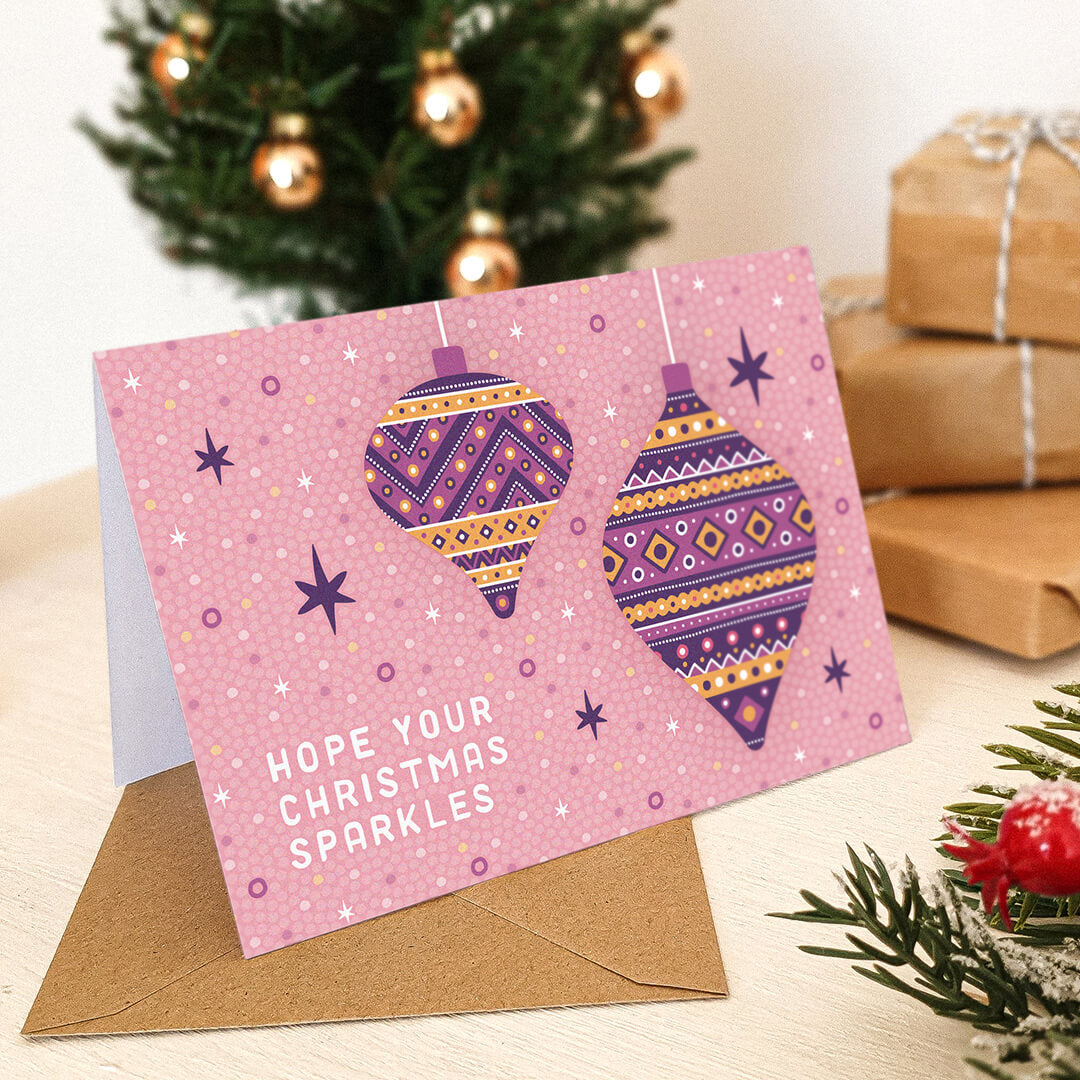 light pink baubles christmas card with purple and gold patterned bauble illustrations Blank inside Recycled kraft brown envelope