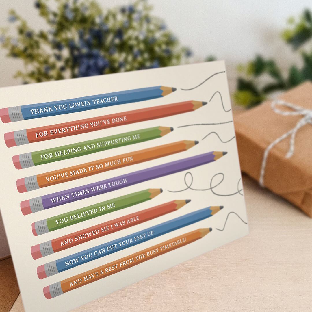 unique thank you teacher card featuring illustrated pencils sat on a cream wooden dresser with plants and gifts in the background