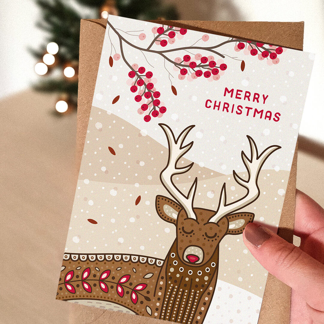 Hand holding unique illustrated stag Christmas card Cute stag Christmas card design Printed on FSC certified card Supplied with kraft brown recycled envelope