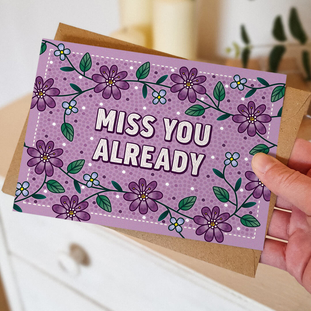 hand holding unique purple floral goodbye card for friend unique miss you already card blank inside recycled kraft brown envelope