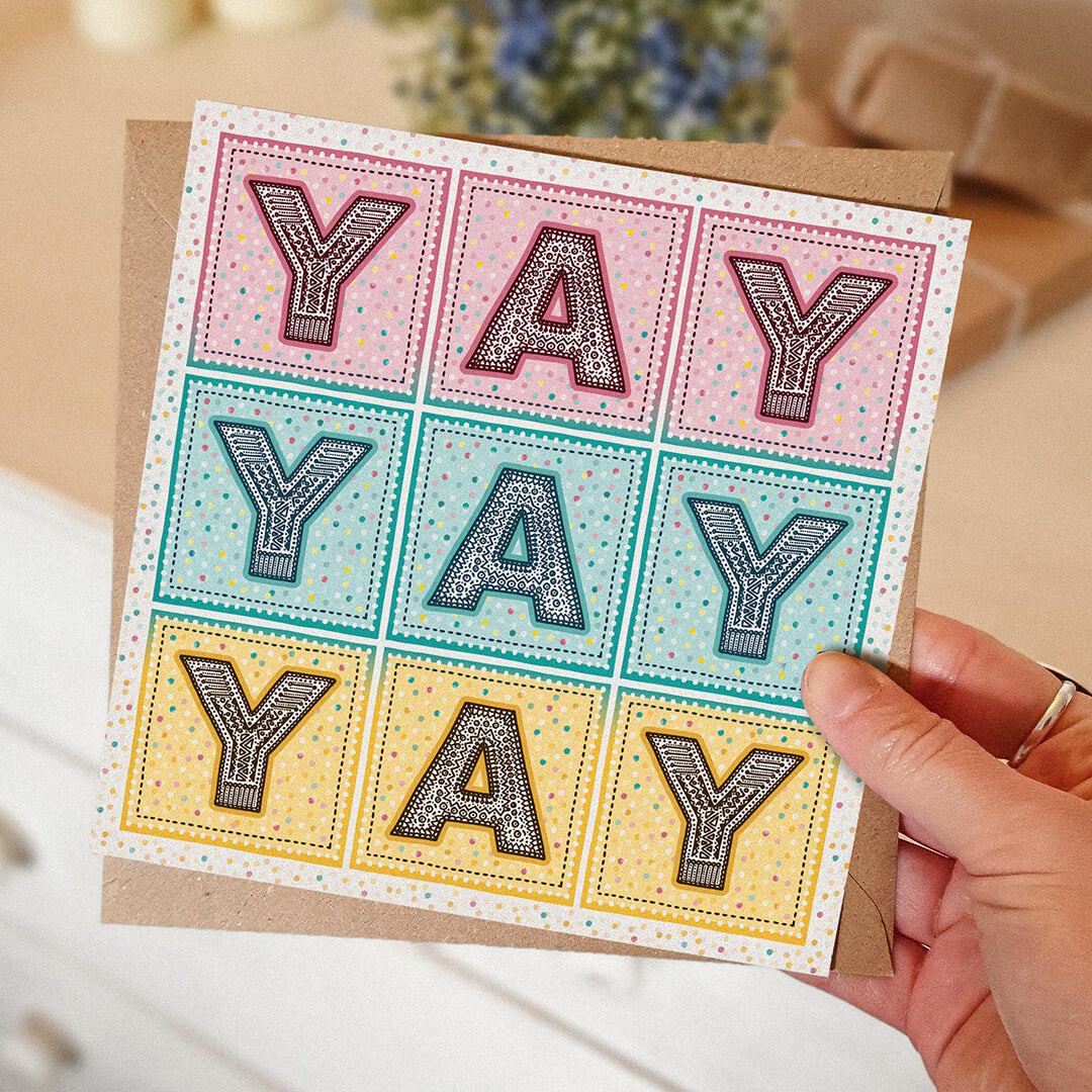 hand holding pink turquoise and yellow yay yay yay congratulations card typographic congratulations card pastel colours Printed on FSC-certified card and supplied with a recycled kraft brown envelope