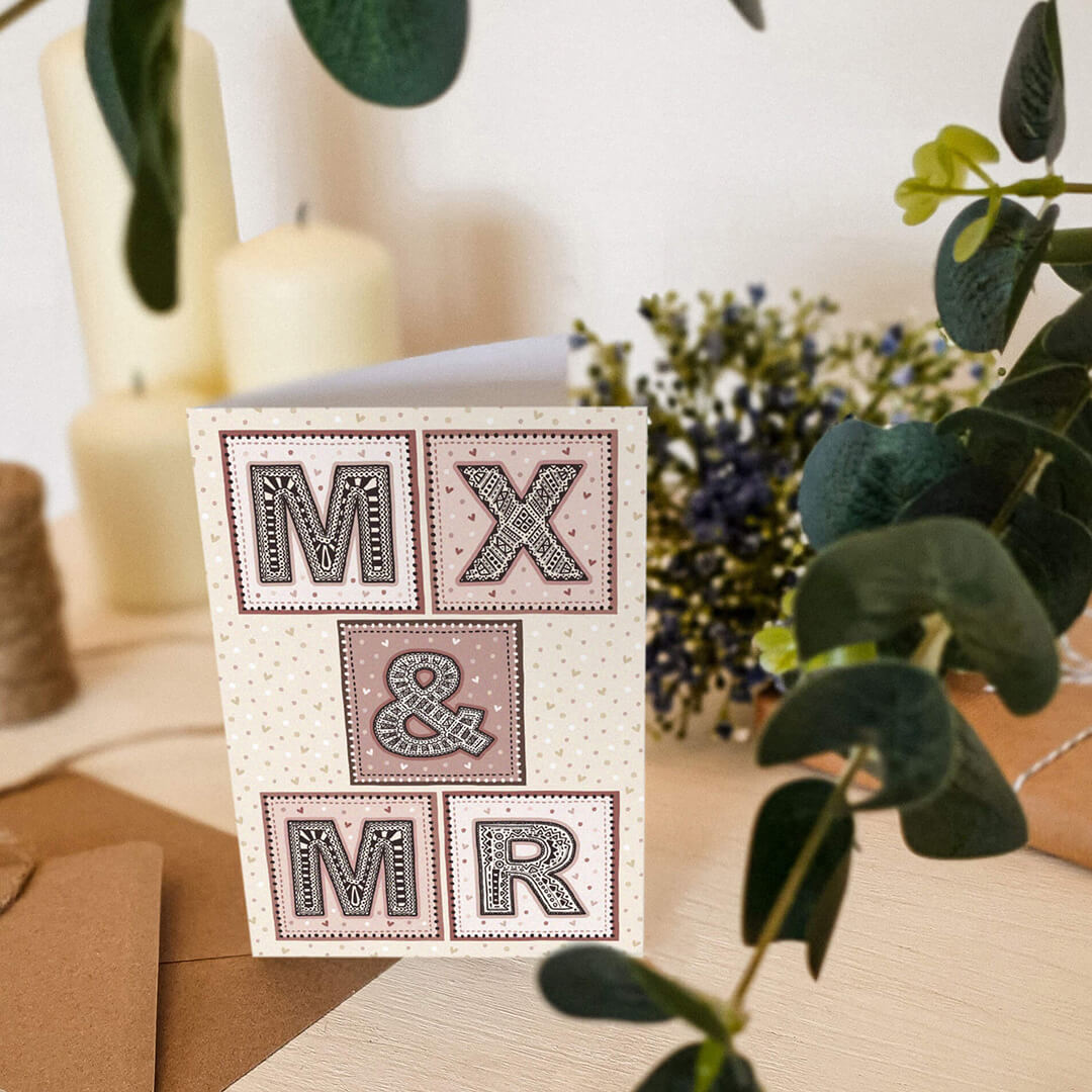 Pink and cream Mx and Mr gender neutral wedding card featuring a beautiful typographic design For male and non-binary couple Printed on FSC-certified card and supplied with a recycled envelope