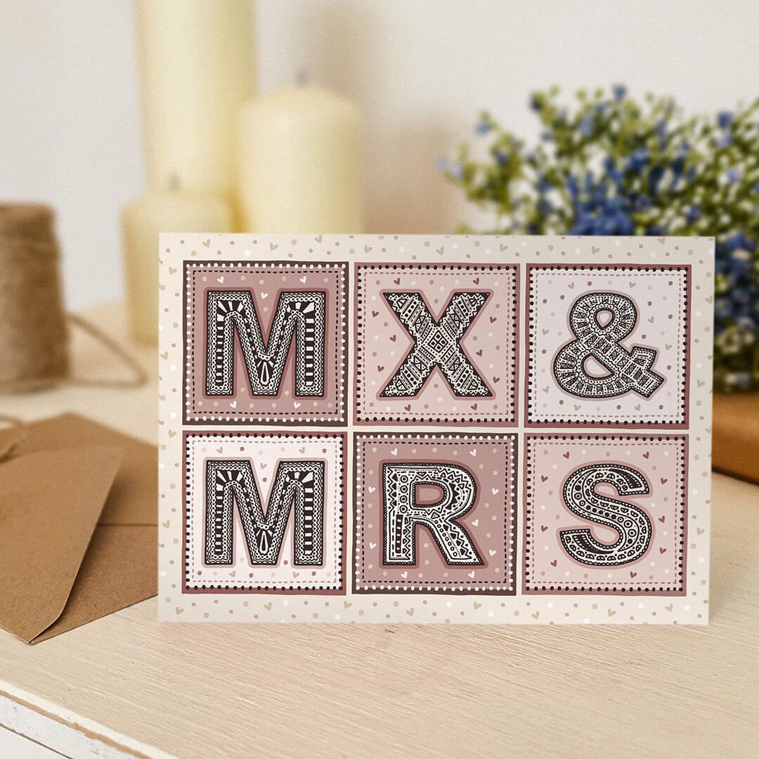 pink and cream non gendered wedding card Featuring mx and mrs written in highly intricate typography Printed on recycled card and supplied with a recycled envelope