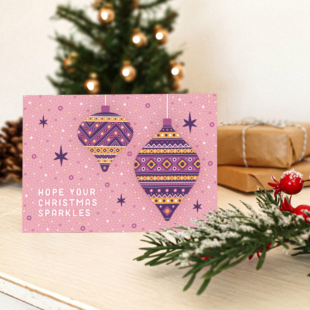 light pink christmas card with bauble illustrations and hope your christmas sparkles message Part of the pink and purple disco bauble christmas card multipack Blank inside Supplied with kraft brown recycled envelopes