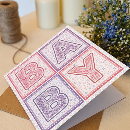 unique pink and purple typographic new baby card Supplied with kraft brown recycled envelope Blank inside