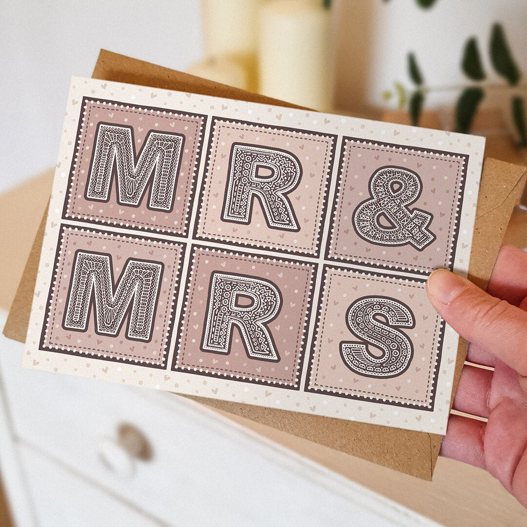 Hand holding Mr & Mrs wedding card Unique pink cream typographic wedding card Printed on FSC-certified card with kraft brown recycled envelope Blank inside