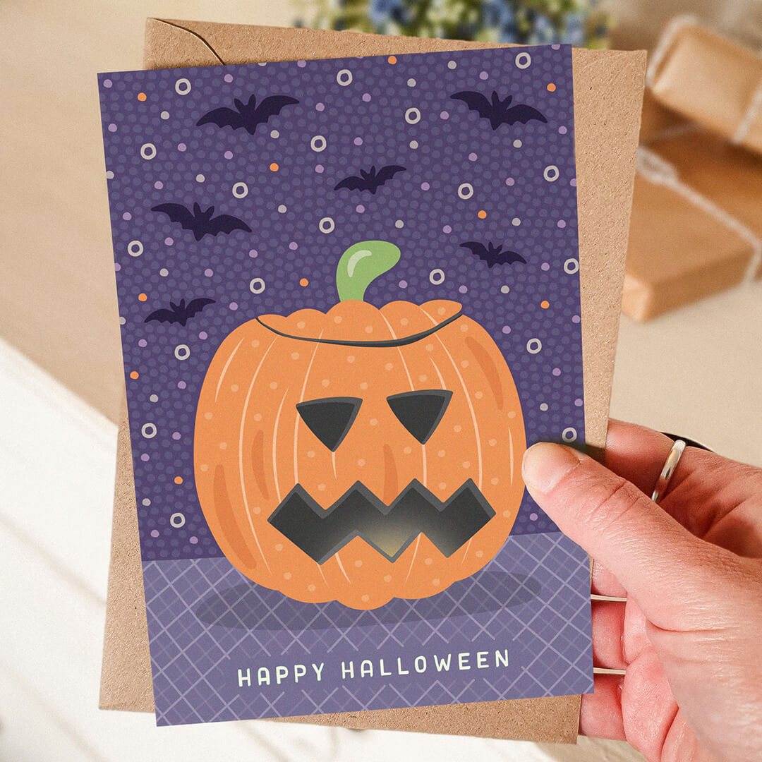 hand holding unique purple and orange illustrated pumpkin halloween card Printed on FSC-certified card Blank inside