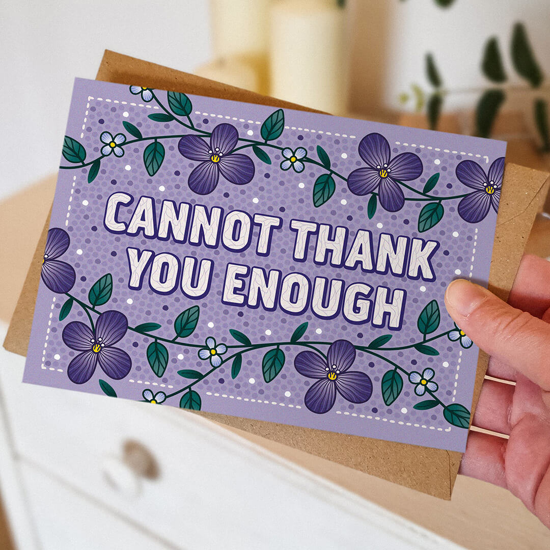 Hand holding purple floral thank you card with thoughtful cannot thank you enough message Unique purple thank you card featuring hand-drawn floral illustrations Printed on FSC-certified card and supplied with a kraft brown recycled envelope