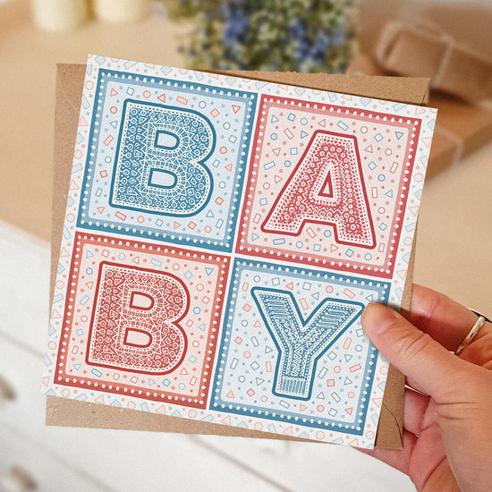 blue and red typographic new baby card