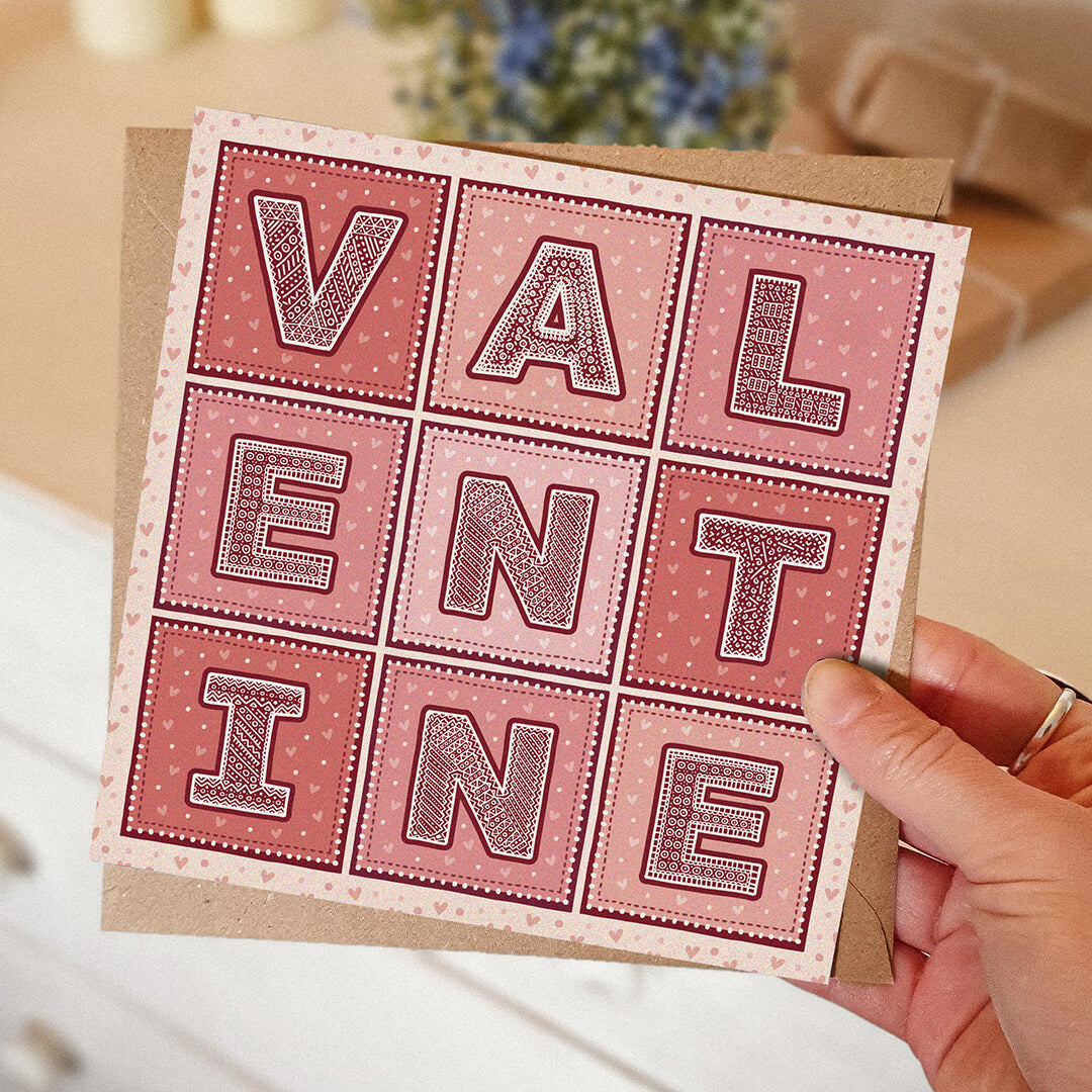 Hand holding unique Valentine's Day card Romantic typographic red pink Valentine's Day card design Printed on FSC-certified card with kraft brown recycled envelope Blank inside