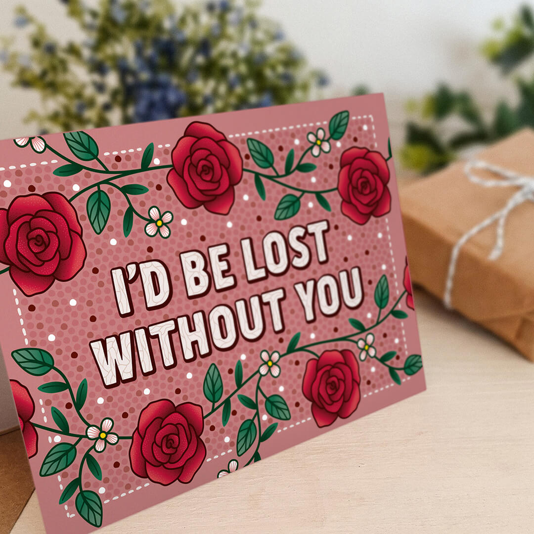 unique red roses anniversary card featuring i'd be lost without you message and rose illustrations blank inside recycled kraft brown envelope