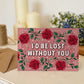 red roses valentines day card featuring i'd be lost without you message blank inside recycled kraft brown envelope