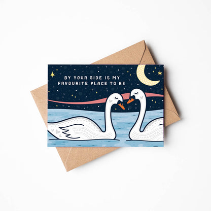 romantic swans anniversary card featuring two swans under a moonlit sky with by your side is my favourite place to be message blank inside recycled kraft brown envelope