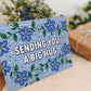unique blue floral thinking of you card blue thinking of you card featuring sending you a big hug message Printed on FSC certified card and supplied with a recycled kraft brown envelope
