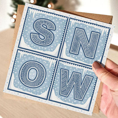Snow Christmas Card with 'SNOW' text held by a hand 