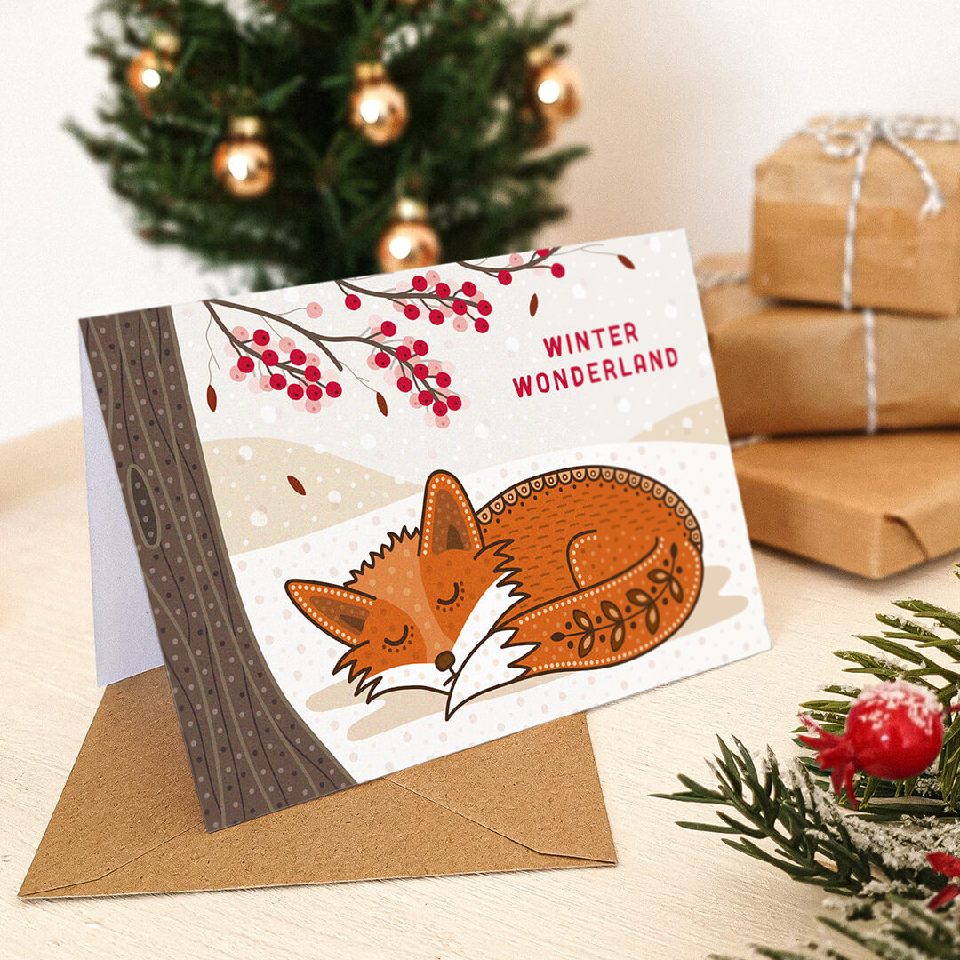 Illustrated Fox Christmas card in snowy Christmas scene by tree with branches covered in berries Unique Christmas card design Blank inside Recycled kraft brown envelope