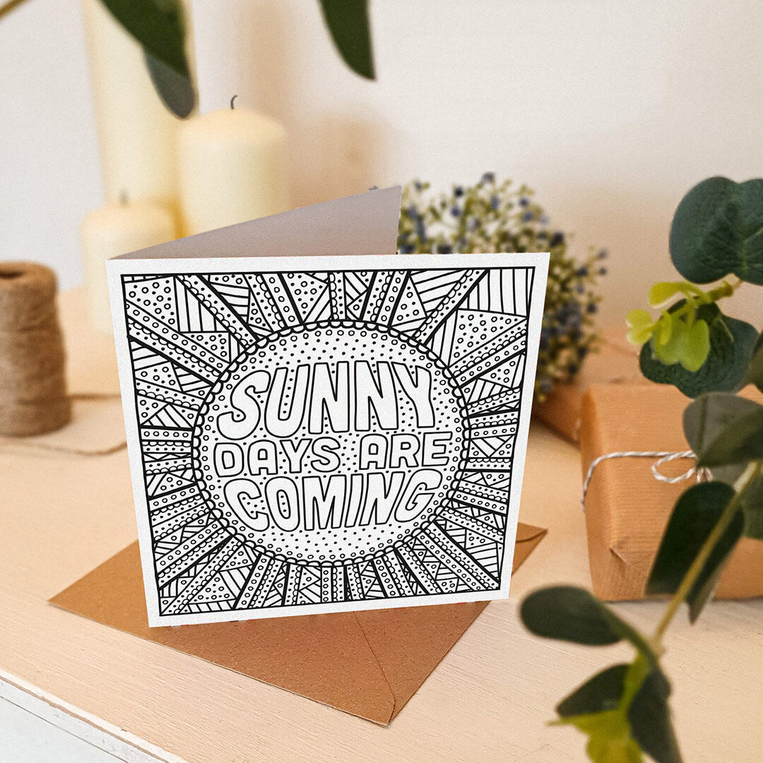lifestyle shot of unique sunshine colouring in card Sunny Days Are Coming positive colouring in card Kraft brown recycled envelope Blank inside