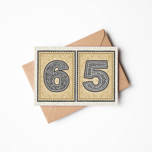 65th birthday card with a gold background and a recycled brown envelope
