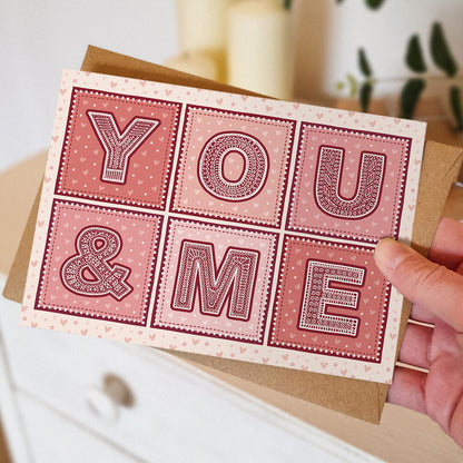 Hand holding red and pink typographic valentine's day card Unique cute You & Me Valentine's Day card Printed on FSC-certified card with kraft brown recycled envelope Blank inside