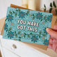 hand holding unique turquoise floral encouragement card for friend unique you have got this card blank inside recycled kraft brown envelope