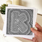 Hand holding letter K colouring in card Unique alphabet colouring in card Patterned typographic greeting card to colour in Blank inside