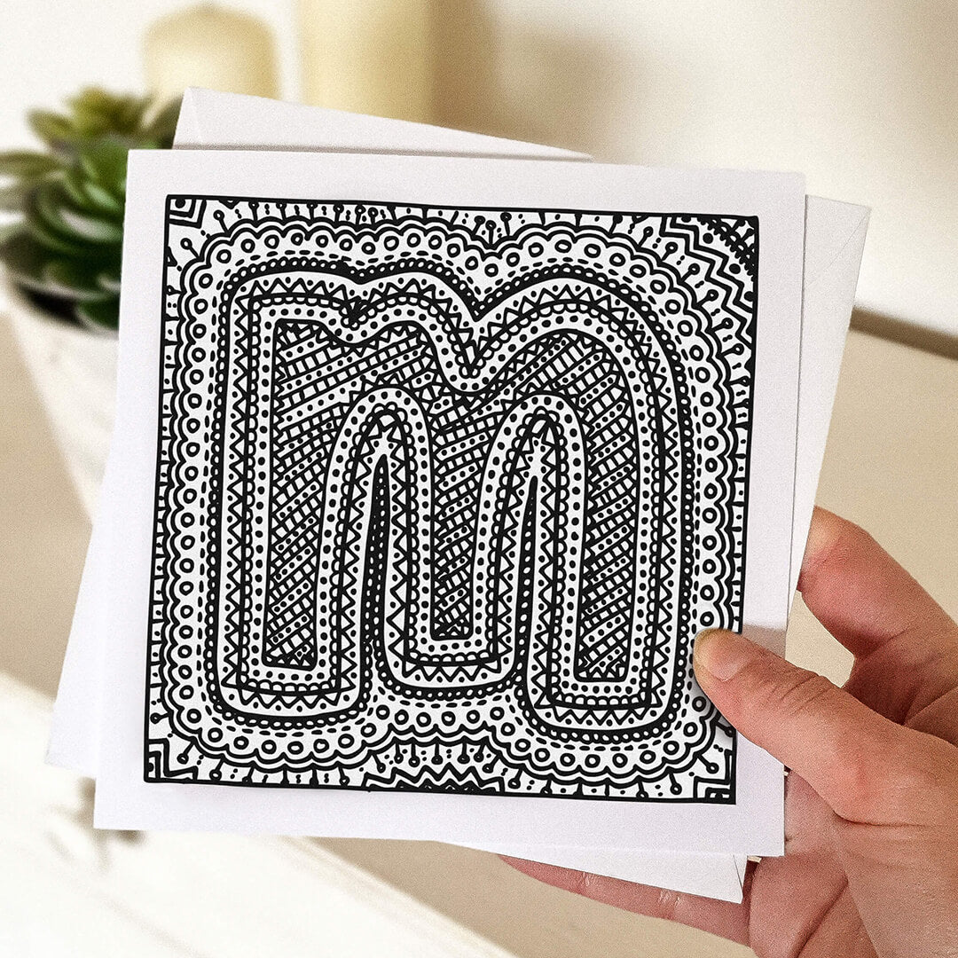 Hand holding letter M colouring in card Unique alphabet colouring in card Patterned typographic greeting card to colour in Blank inside